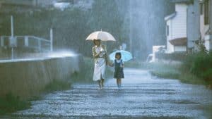 ‘Dark Water’ (2002) Arrow Video 4K UHD Blu-Ray Review – A Thematically Rich Journey Into J-Horror A woman and a child walking down a street in the rain.