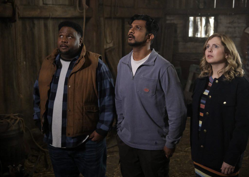 A group of people standing in a barn.