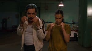 A man and woman standing in a boxing ring.