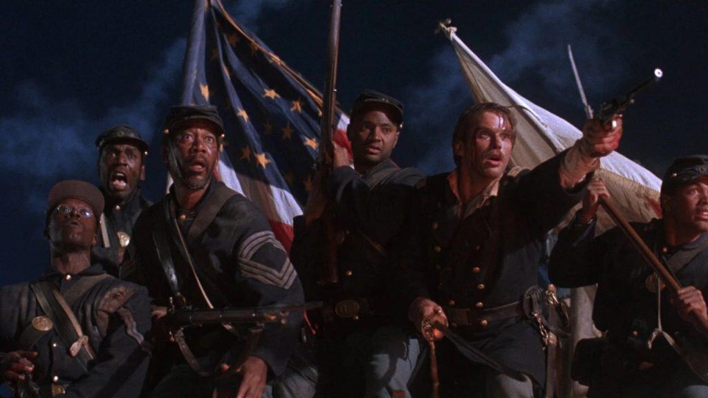 A group of men in uniform holding guns and flags.
