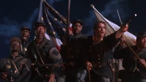 A group of men in uniform holding guns and flags.