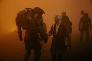 A group of people standing in the middle of a foggy field.