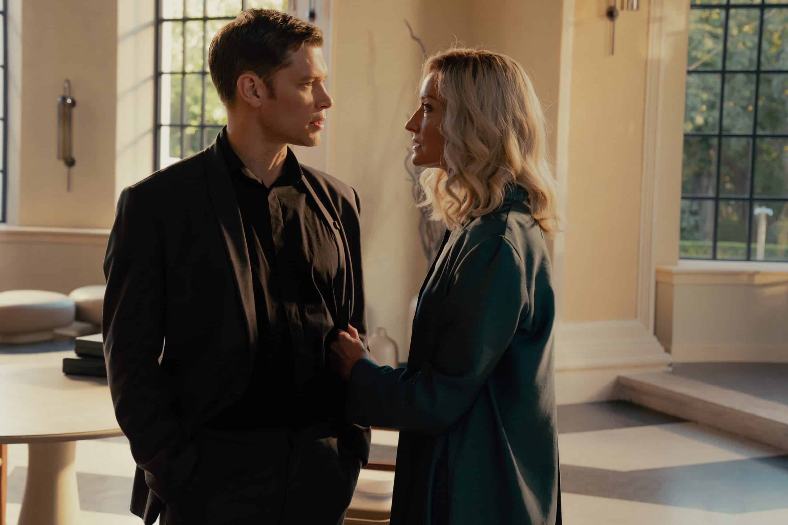 A man and woman standing next to each other in a room.
