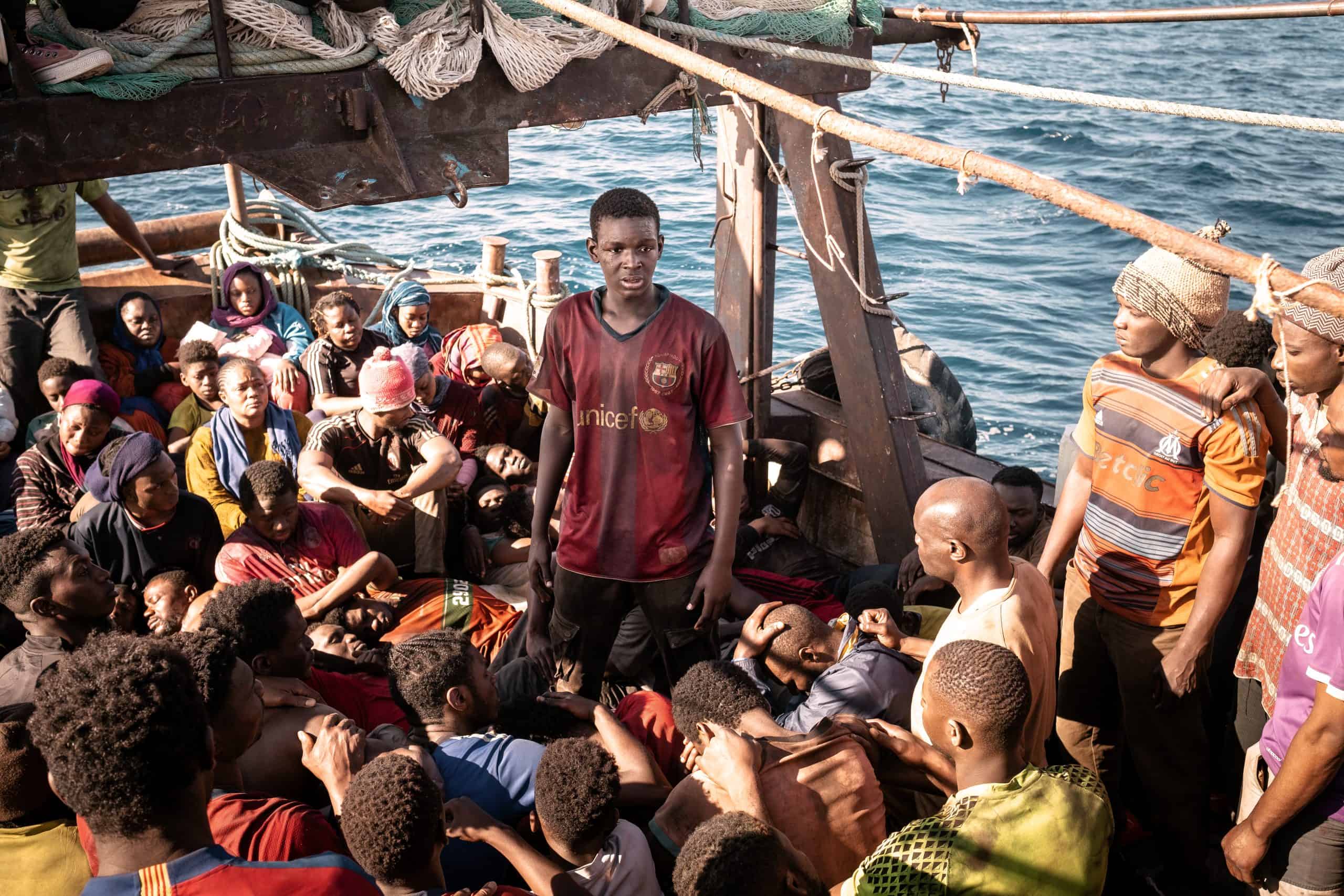 A group of people on a boat in the ocean.