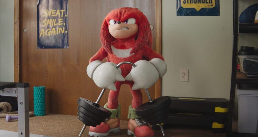 A sonic the hedgehog mascot is standing in a room.