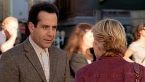 A man talking to a woman on the street.