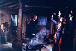 A woman holding a gun and a man holding a gun.