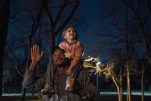 A man carrying a child on his shoulders.