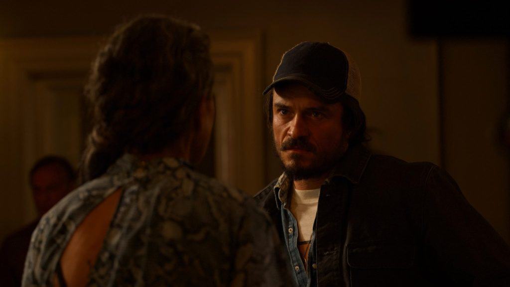 A man is talking to a woman in a room.