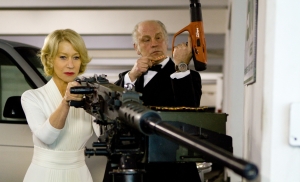 The ‘RED’ Collection 4K UHD Blu-Ray SteelBook Review – The Mindless Action-Comedy Outing You Need A man and a woman holding a machine gun.