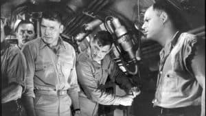 A group of men in military uniforms in a boat.