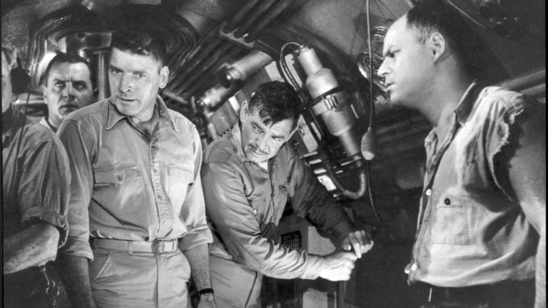 A group of men in military uniforms in a boat.