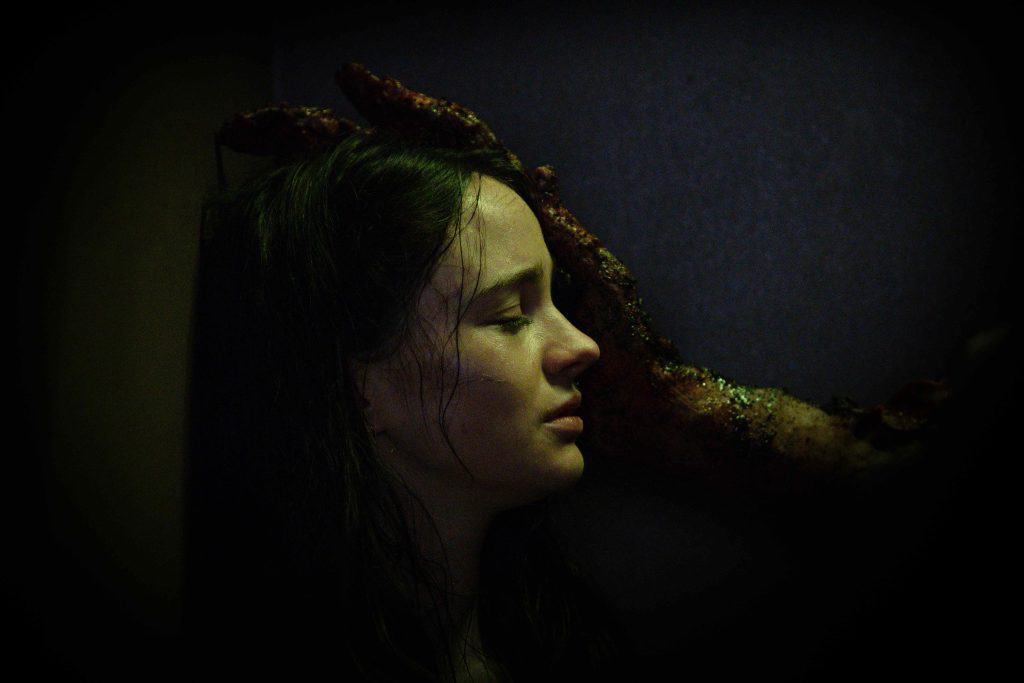 A woman with a hand on her head.