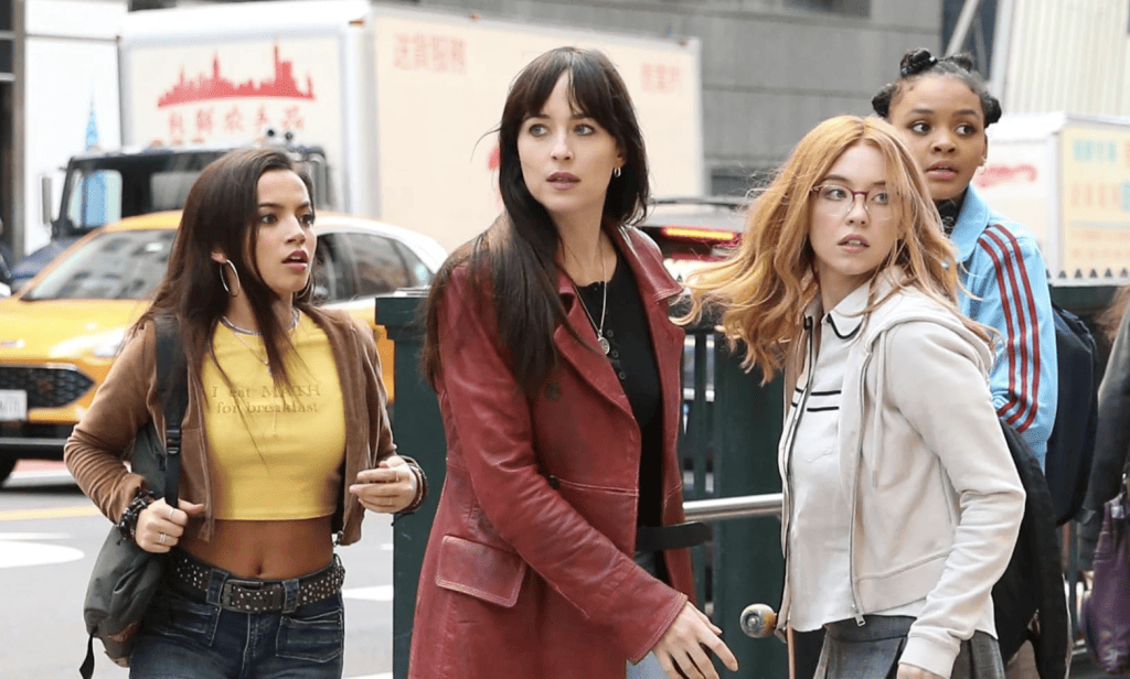 A group of women standing on a city street.