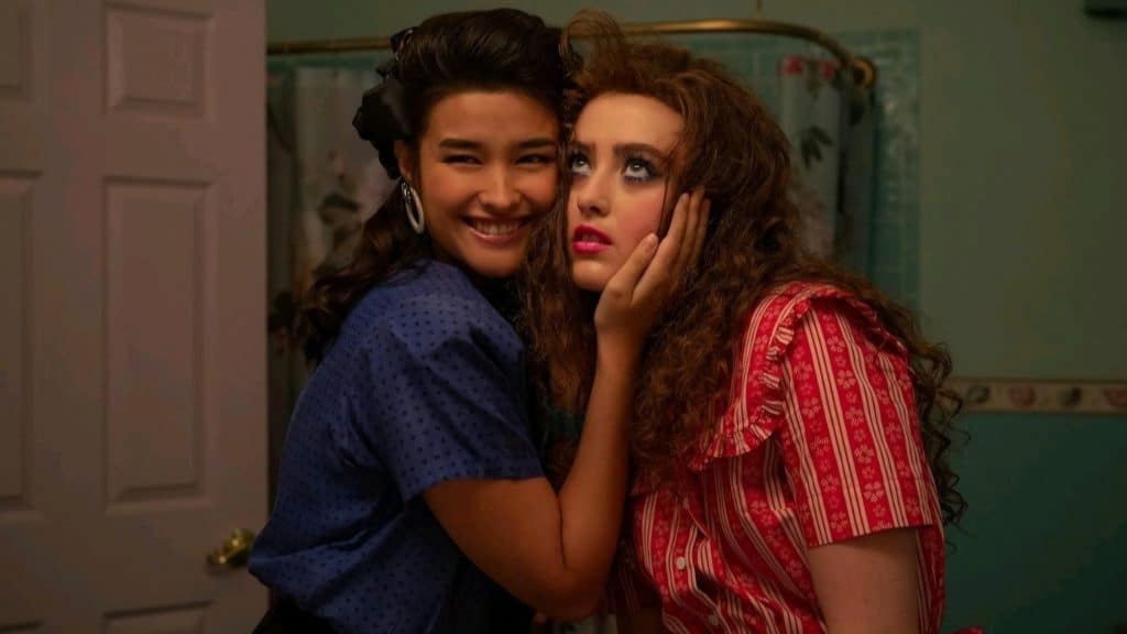 Two women posing for a picture in a bathroom.