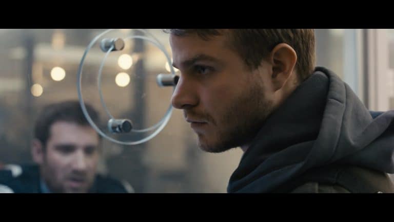 ‘Simon Killer’ Blu-Ray Review – A Visceral Look Inside Quiet Evil A man looking through a glass window.