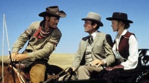 ‘The Big Country’ (Special Edition) Blu-Ray Review – William Wyler Crafts One Of The Great Westerns Three people in cowboy hats sitting in a horse drawn carriage.
