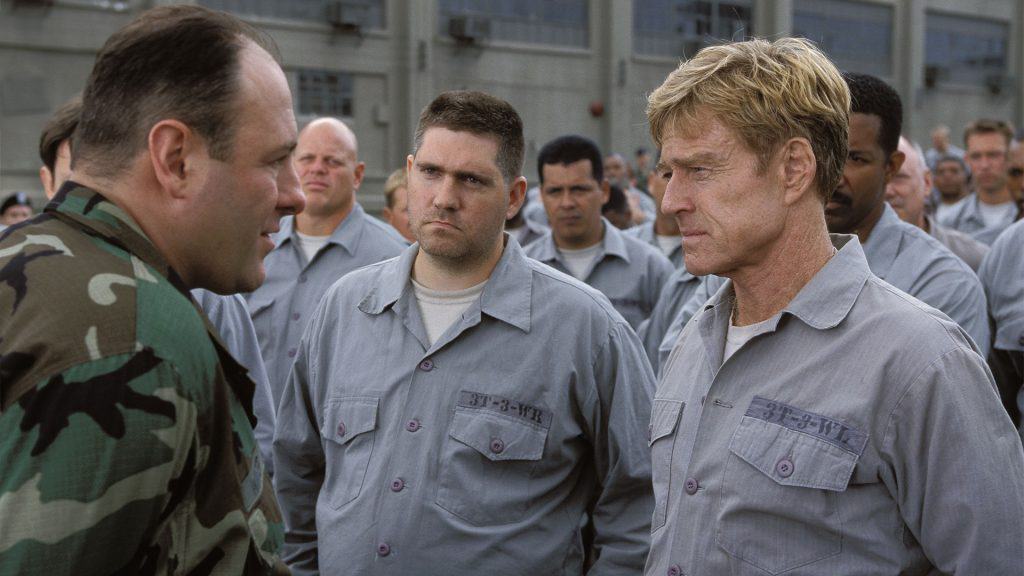 A group of men in uniform talking to each other.