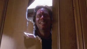 Stephen King’s ‘The Shining’ (1997) Blu-Ray Review – Legendary Author Takes A Stab At A More Faithful Adaptation A man peeking out of a hole in a door.