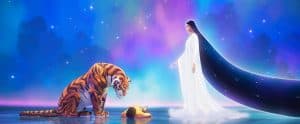 A woman and a tiger in the water.