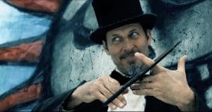 A man in a top hat holding a wand.