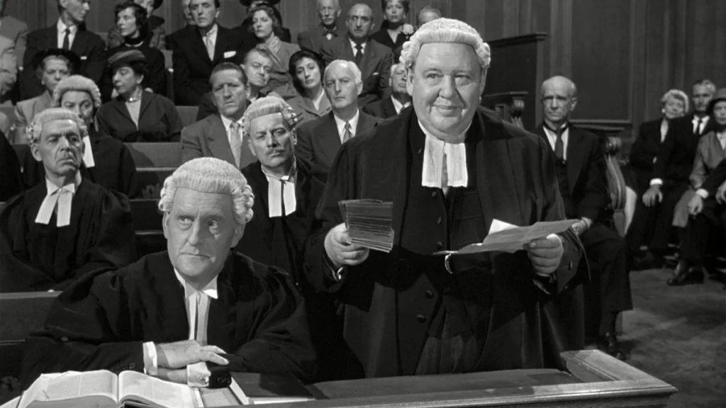 A black and white photo of a group of people sitting in a courtroom.