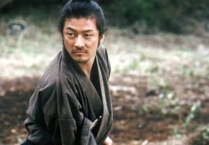 A man in a samurai costume is holding a sword.