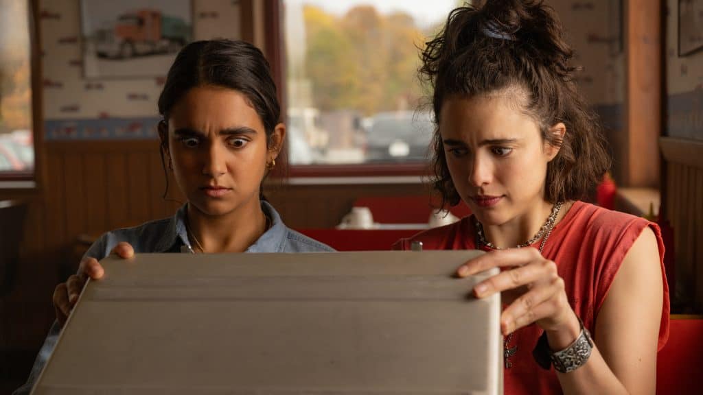 Two women looking at a box.