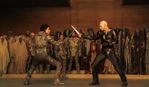 ‘Dune: Part Two’ 4K UHD Blu-Ray Review – A Bombastic Mixture Of Spectacle & Storytelling Two men are fighting in front of a large group of people.
