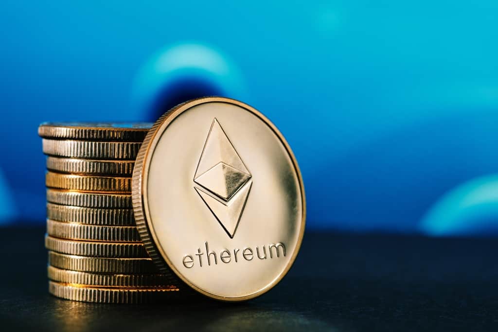Stack of ethereum coins against a blue background.