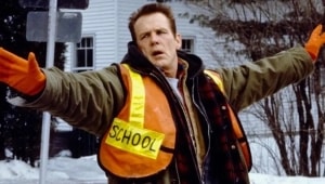 ‘Affliction’ Blu-Ray Review – Paul Schrader’s Oscar-Nominated Dive Into Generational Trauma A school crossing guard in a reflective vest gesturing with his arms in a snowy setting.