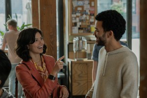 A man and woman talking in a coffee shop.