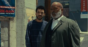 A man standing next to another man.