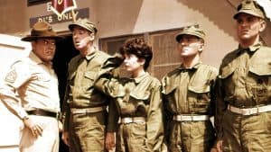 A group of people in military uniforms standing in front of a building.