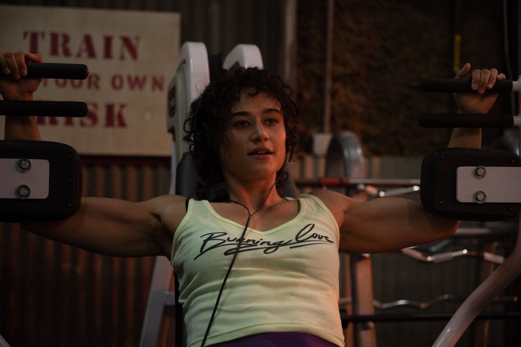 A woman lifting weights in a gym.