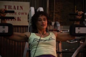 A woman lifting weights in a gym.