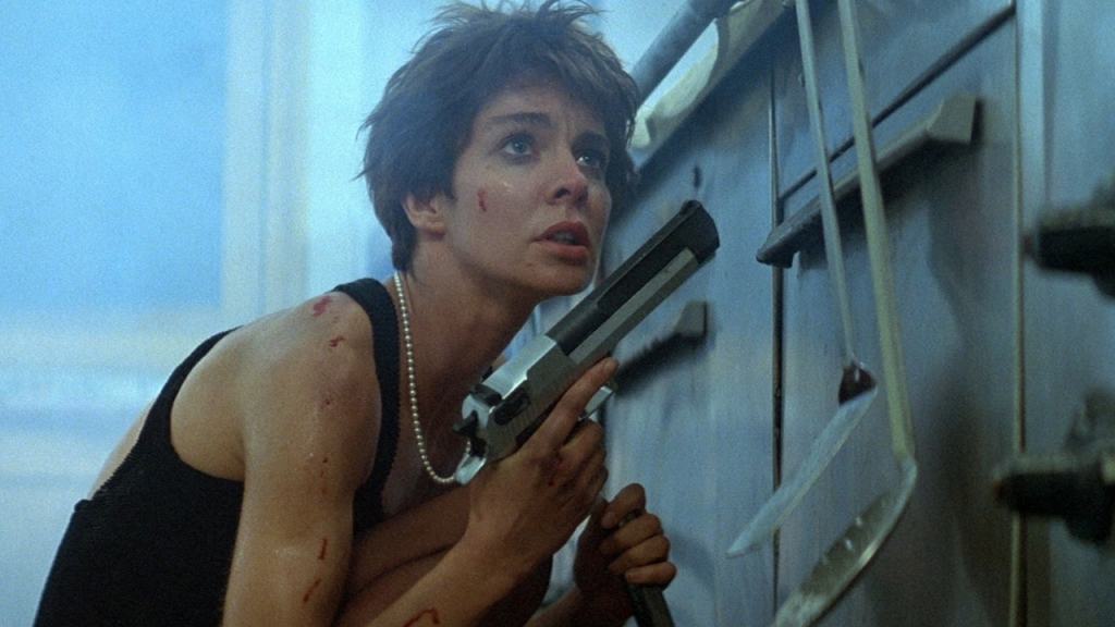 Woman with a gun looking anxious in a tense situation.