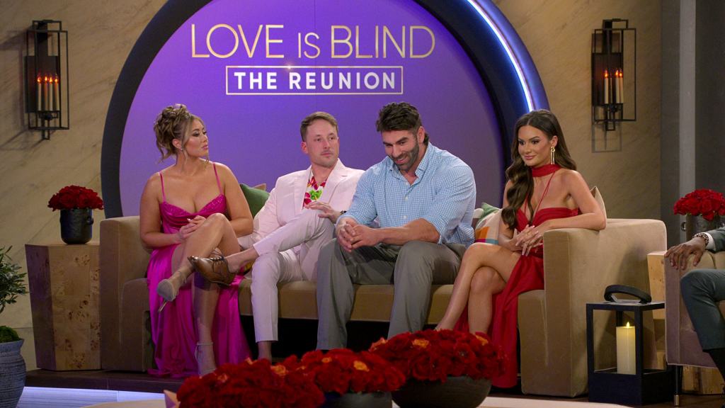 Participants seated on a couch at the "love is blind: the reunion" special.