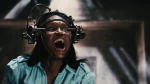 Lionsgate To Give A Trio Of ‘Saw’ Sequels Their 4K UHD Blu-Ray Debut This November A woman with a machine on her head.