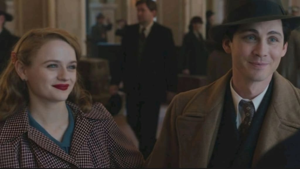 A man and woman in vintage clothing smiling at each other, with people walking in the background.