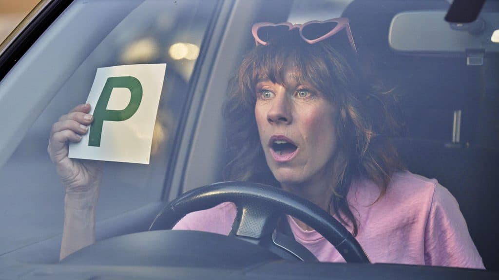 A woman in a car.