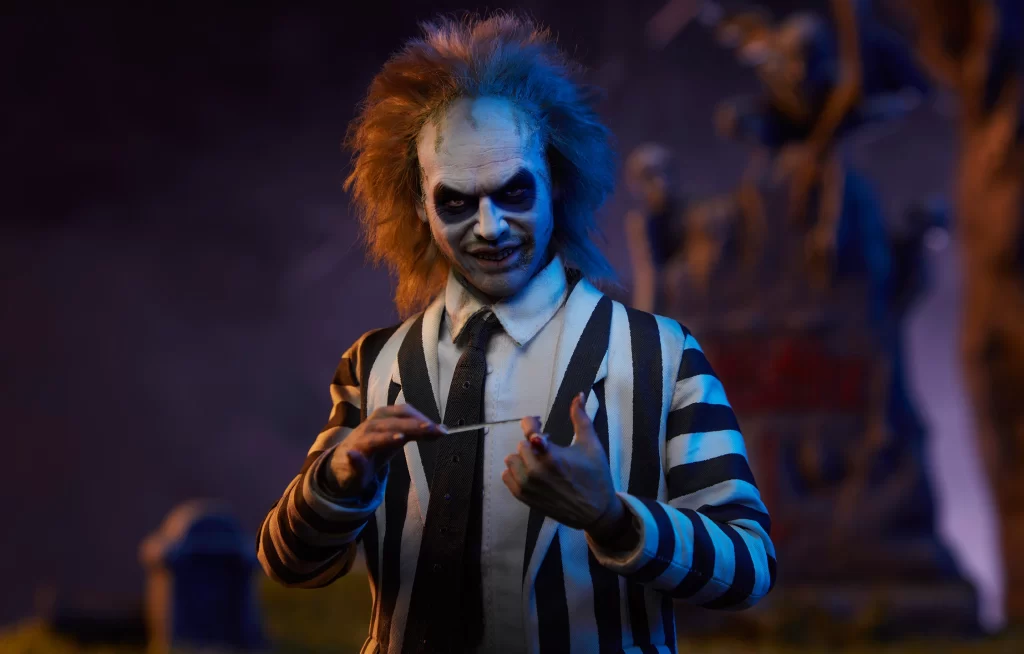 A figure resembling a character from the movie 'beetlejuice' posing in a striped suit with an eerie background.