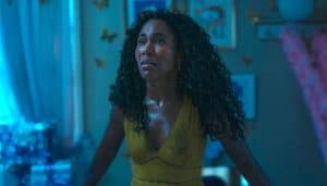 A woman in a yellow dress standing in a room.