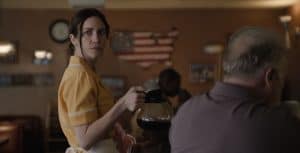 GVN’s Guide To The 2024 Oscar-Nominated Short Films A woman in a yellow apron is serving coffee in a diner.