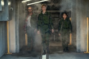 ‘Godzilla x Kong: The New Empire’ 4K UHD Blu-Ray Review – Monsterverse Sequel Offers Large-Scale Destruction Three people in military uniforms walking through a smoky corridor with a determined look.