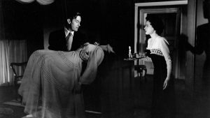 A man in a dress and a woman in a dress.