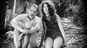 Accidentally Preserved: Volume 5 Blu-Ray Review – An Entertaining Grab Bag Of Silent-Era Gems Two individuals in vintage attire sitting on the ground in a wooded area, appearing pensive or in contemplation.