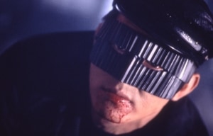 ‘Black Mask’ (1996) Limited Edition Blu-Ray Review – Occasionally Silly, Bone-Crunching Fun With Jet Li A person with a futuristic visor and a bloodied lip.