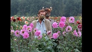 ‘Kin-Dza-Dza!’ Blu-Ray Review – Absurdist Sci-Fi Comedy Is A Brilliant Discovery That Should Not Be Missed Two men wearing gas masks standing in a vibrant field of multicolored dahlias.