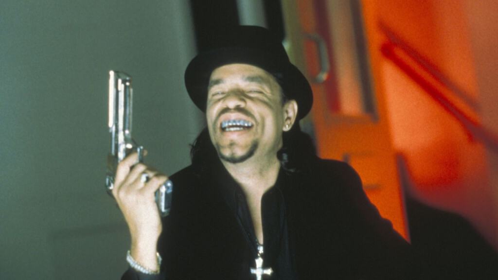 A man in a top hat holding a revolver and laughing.